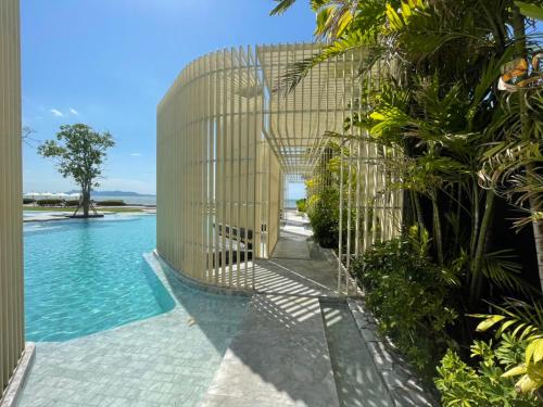 a pool with a metal fence next to a building at Residence By Hello Pattaya At Veranda in Jomtien Beach