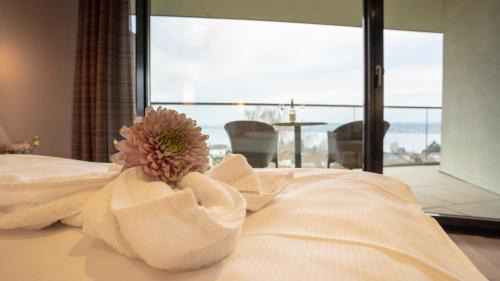 a hotel room with a flower in a towel at Parkhotel St.Leonhard in Überlingen
