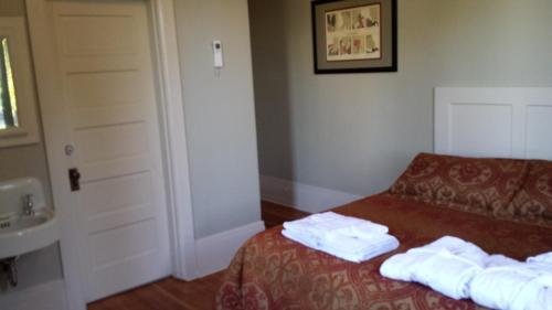 a hotel room with a bed with towels on it at Centralia Square Grand Ballroom and Vintage Hotel in Centralia