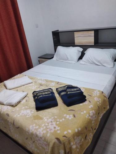a bed with two pillows on top of it at Bungalow at Pereybere in Grand-Baie