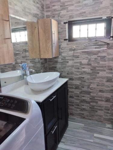 a kitchen with a bowl on a counter and a sink at Bungalow at Pereybere in Grand-Baie