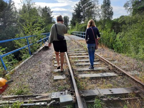 a man and a woman walking down train tracks at Furudals Vandrarhem och Sjöcamping in Furudal