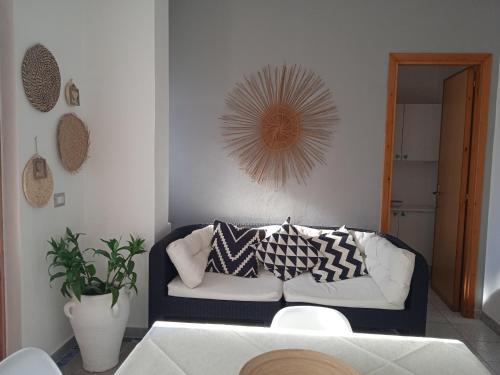 a living room with a couch and a mirror at Guest House Oleandro IUN 2727 in Santa Maria Navarrese