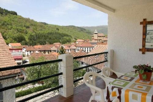 a balcony with a table and a view of a city at Casa Rural Mantxoalorra in Ochagavía
