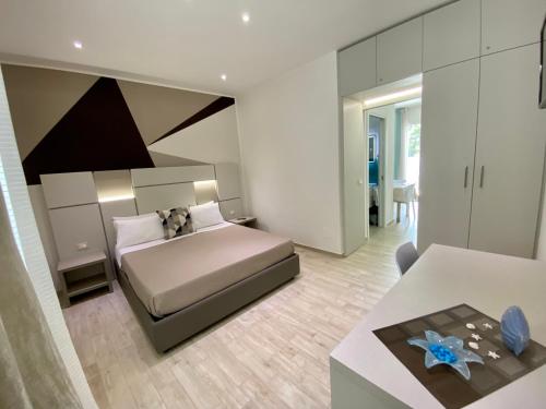 a bedroom with a bed with a dog sitting on it at Lux apartments in Porto Cesareo
