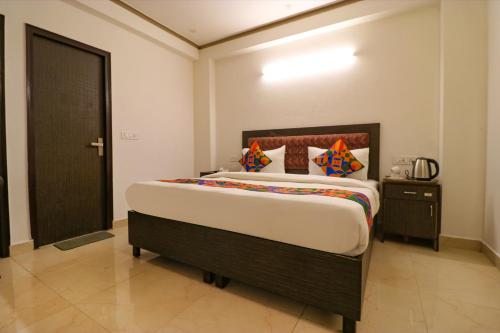 a bedroom with a large bed in a room at FabExpress Dolphin International in New Delhi