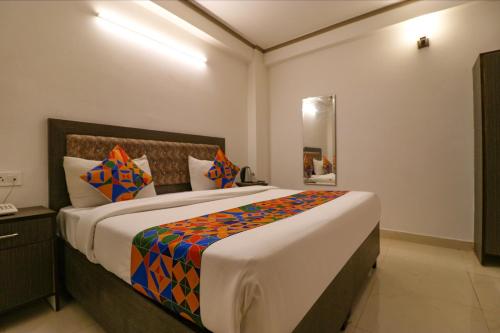a bedroom with a large bed in a room at FabExpress Dolphin International - Nr IGI Airport New Delhi in New Delhi