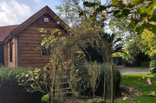 a building with a tree in front of it at Chalet Duras in Sint-Truiden