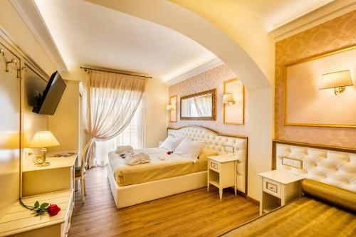 una camera d'albergo con letto e TV di Hotel Mazzanti a Milano Marittima