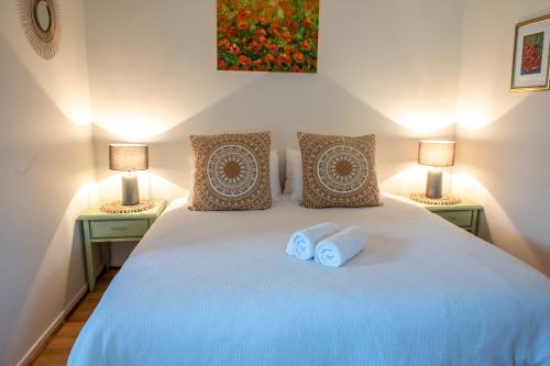 a bedroom with a large bed with two lamps at Bower On Becket - Couples Retreat in Rye