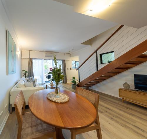 a living room with a table and a couch at MARGARET FOREST RETREAT Apartment 129 - Located within Margaret Forest, in the heart of the town centre of Margaret River, spa apartment! in Margaret River Town