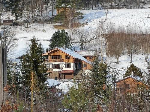 a wooden house in the snow with snow on it at Kamenná stráň in Metylovice