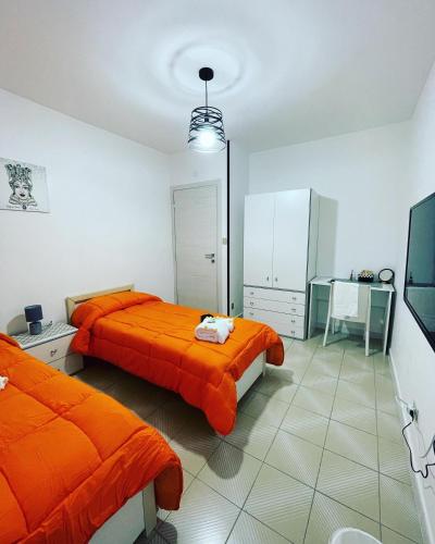 a bedroom with two beds and a tv in it at B&B Marrelli Crotone in Crotone