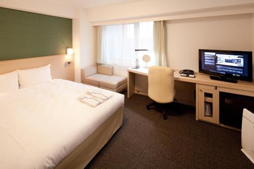Ένα ή περισσότερα κρεβάτια σε δωμάτιο στο Daiwa Roynet Hotel Tokyo Akabane