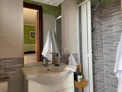a bathroom with a sink and a mirror at Residence Don Turi in Villafranca Tirrena