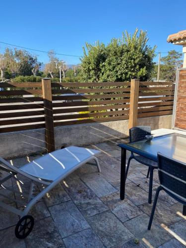 a bench and a table in front of a fence at Mariana Plage in La Marana
