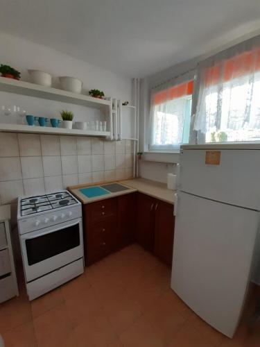 kuchnia z białą kuchenką i białą lodówką w obiekcie Apartament blisko morza - Yellow Stone w Gdańsku