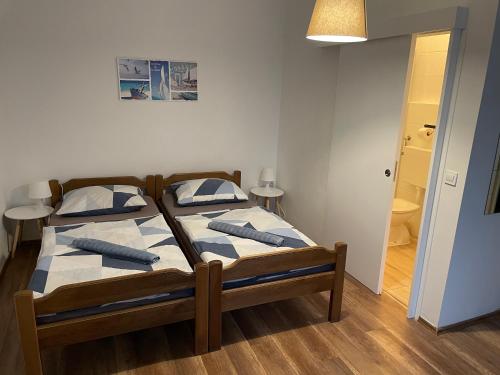 a bedroom with a bed with blue and white sheets at Nine Sveti Juraj in Sveti Juraj