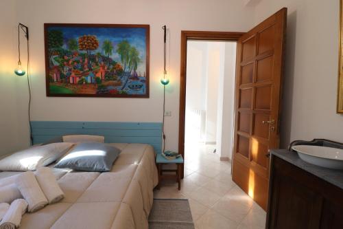 a bedroom with a large bed and a sink at Relais Delle Rose in Lecce