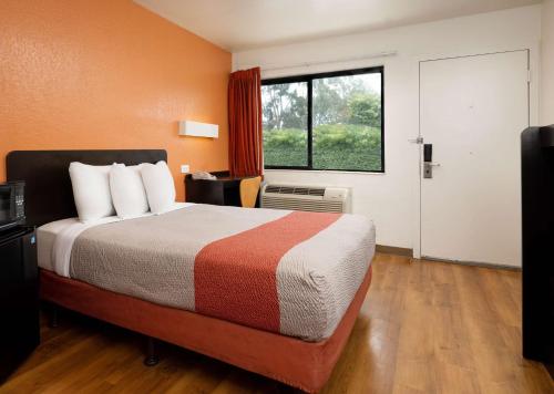 a hotel room with a bed and a window at Motel 6-Camarillo, CA in Camarillo
