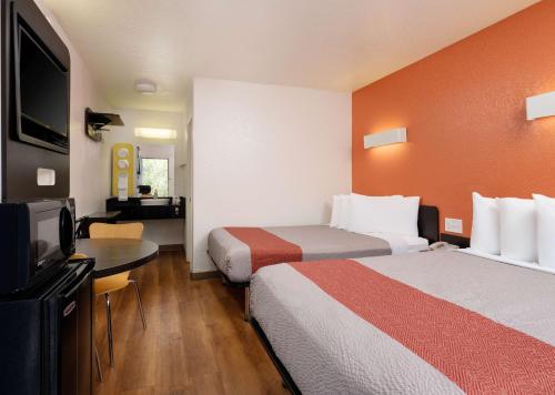 a hotel room with two beds and a flat screen tv at Motel 6-Camarillo, CA in Camarillo
