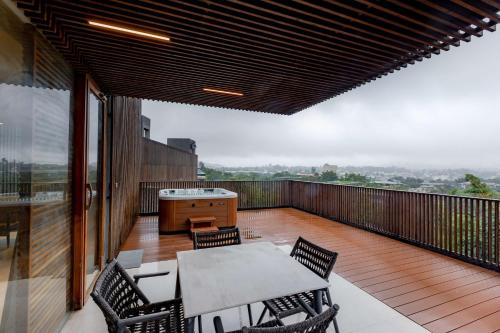 a patio with a table and chairs on a balcony at Radisson Resort and Spa Lonavala in Lonavala