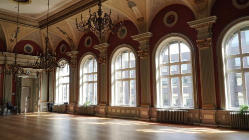 a large room with large windows and a chandelier at Comfort Hotel Malmö in Malmö