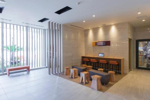 un hall avec des chaises et un bar dans un bâtiment dans l'établissement Tokyu Stay Shimbashi - Ginza area, à Tokyo