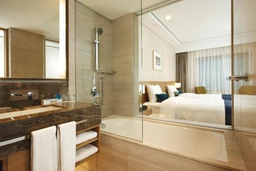 a kitchen with a white sink and white cabinets at Novotel Ambassador Seoul Gangnam in Seoul
