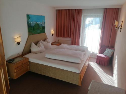 a hotel room with a bed and a window at Landhaus Laner in Fulpmes