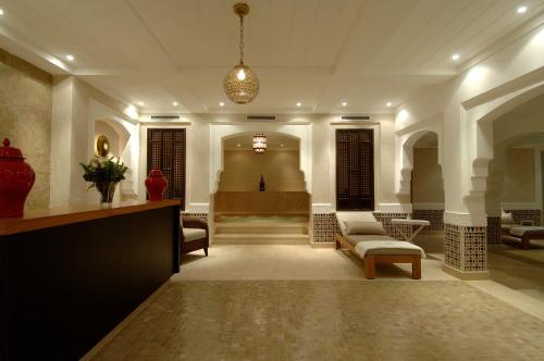 a lobby with a waiting area with a couch and chairs at Le Riad Villa Blanche in Agadir