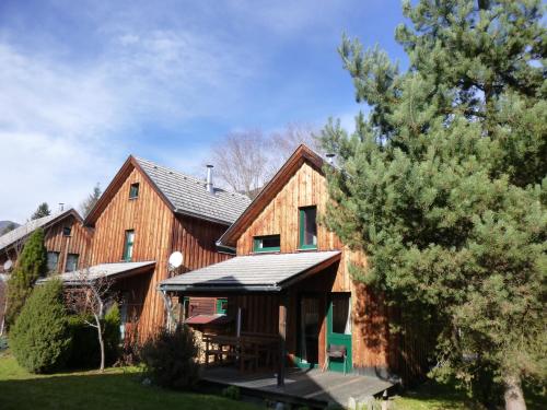 a large wooden house with a gazebo at Alpenferienhaus Kreischberg in Sankt Lorenzen ob Murau