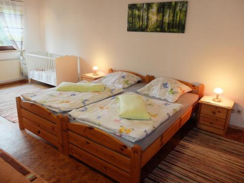 a bedroom with a wooden bed with two night stands at Haus Alpaka in Bad König