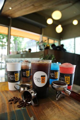 a table with three cups of coffee and coffee beans at Ever8 Serviced Residence in Seoul