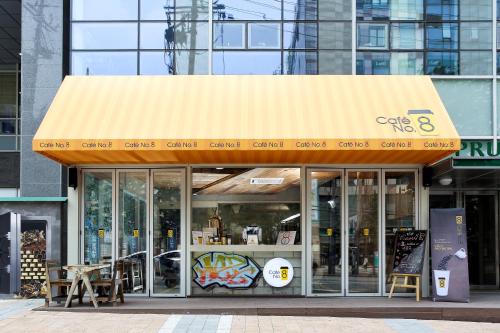 a store front of a building with a yellow awning at Ever8 Serviced Residence in Seoul