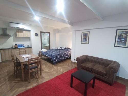 a living room with a bed and a table and a couch at Apartamento de lujo en la Sierra in Becerril de la Sierra