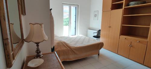 a bedroom with a bed and a mirror and a lamp at Casa Vacanze Varuga in Praia a Mare