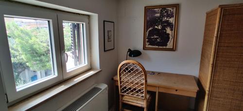 a room with a wooden desk and a window at Casa Vacanze Varuga in Praia a Mare