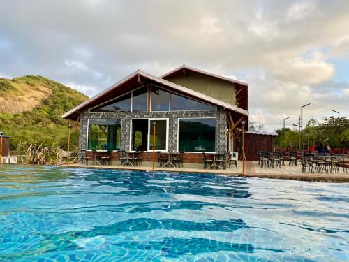 a house with a swimming pool in front of it at Mastiff Grand La Villae in Lonavala