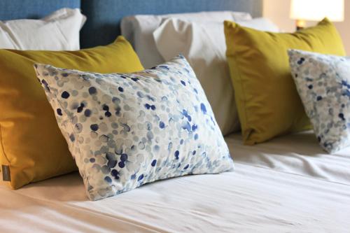 a bed with blue and white pillows on it at Quinta da Luz - A Luxury Boutique B&B in Silves
