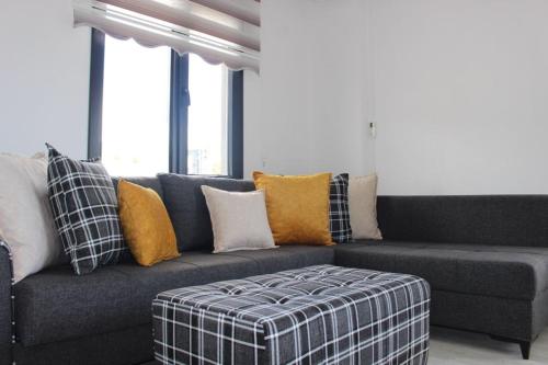 a living room with a blue couch with yellow pillows at Riva Marina in Kusadası