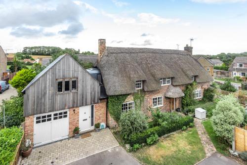 an old brick house with a gray roof at Barton Cottage Bed and Breakfast in Broadmayne