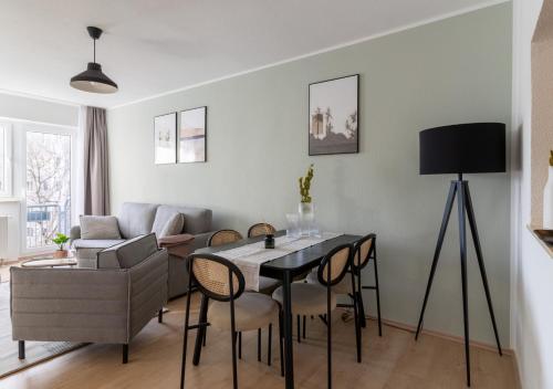 a living room with a table and a couch at Limehome Magdeburg Breiter Weg in Magdeburg