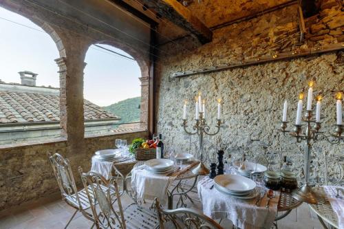 a dining room with a table in a stone wall at Palazzo Giusti, Understated Luxury with a Welcoming Ambience on the Hills of Lucca in Pescaglia