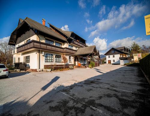 a large house sitting on the side of a street at Guesthouse Leski Dvor in Lesce
