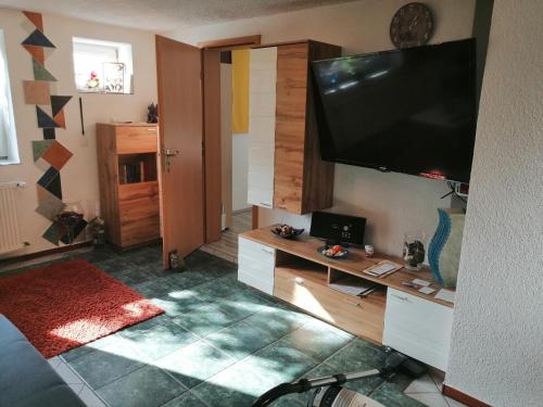 a living room with a flat screen tv on the wall at Ferienwohnung Palm in Monschau