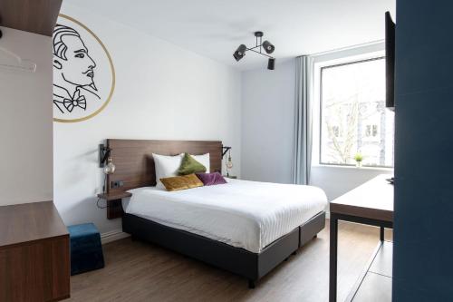 a bedroom with a bed and a window at Alex Maastricht in Maastricht