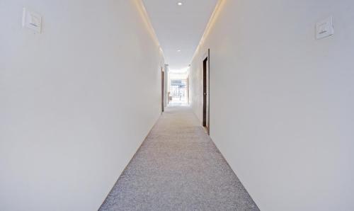 an empty corridor in a building with doors open at Itsy Hotels Shivshakti in Aurangabad