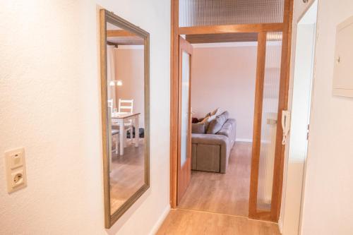a mirror in a living room with a couch at Ferienapartment Landwohnung Laura in Winterberg
