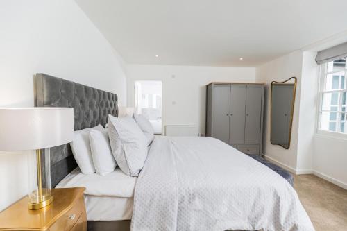 a bedroom with a white bed and a couch at Elizabeth Flat 5 - By Luxury Apartments in Cheltenham